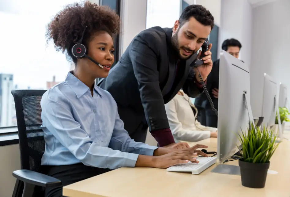 Team working on computer at customer support desk