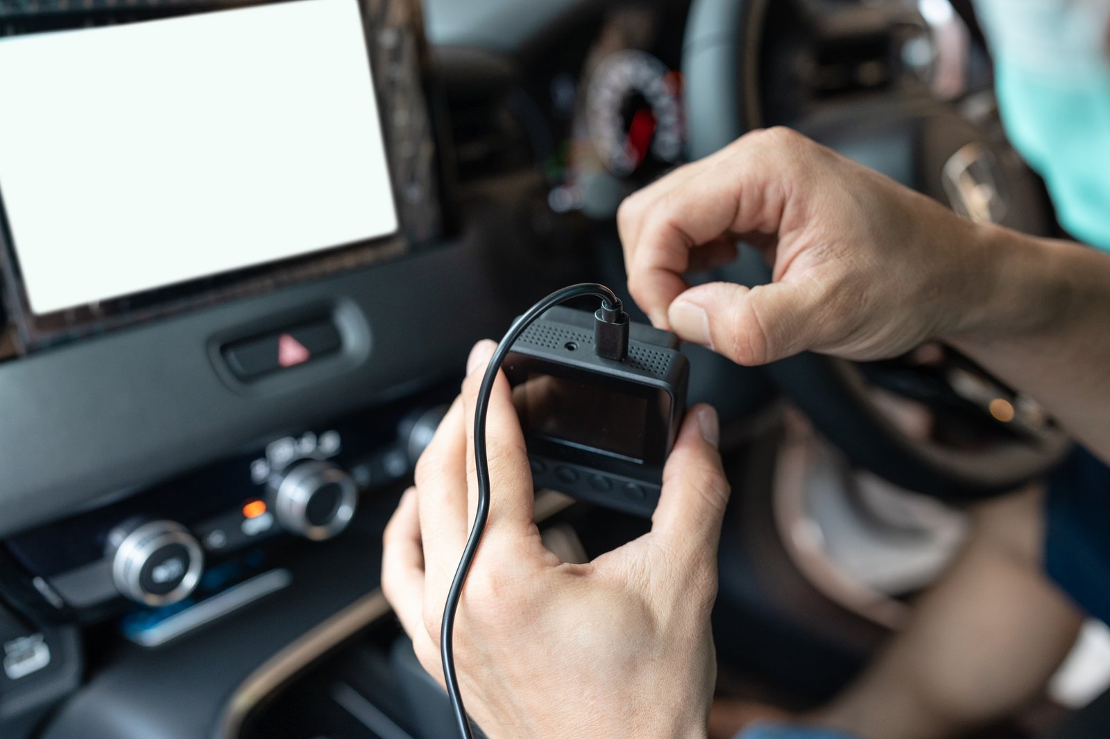 Hand of technician preparing and installing front camera car recorder